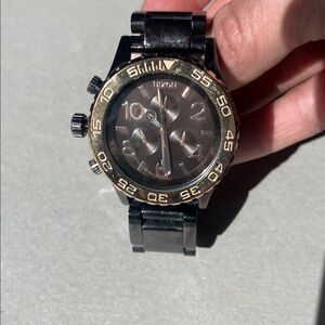 Nixon Black and Gold Chronograph Timepiece